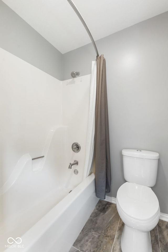 bathroom featuring shower / bathtub combination with curtain, tile patterned floors, and toilet