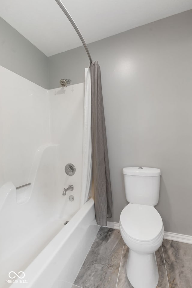 bathroom featuring toilet, shower / tub combo, and tile patterned flooring