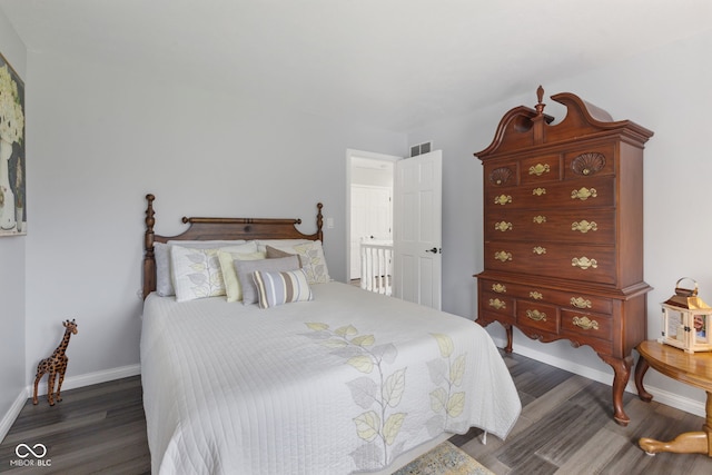 bedroom with dark hardwood / wood-style flooring