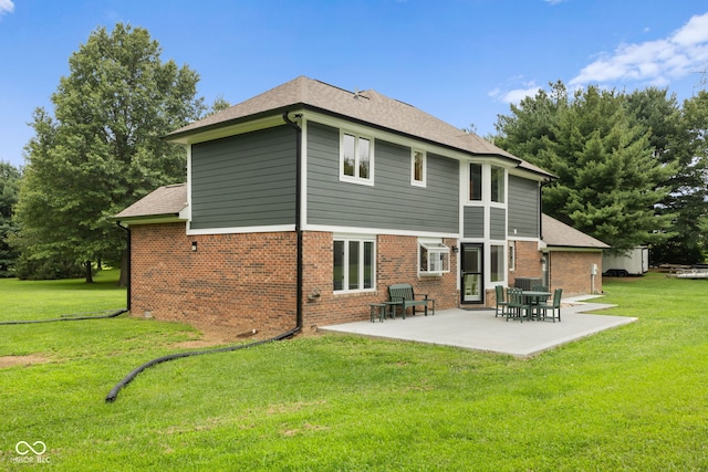 back of property with a patio and a lawn