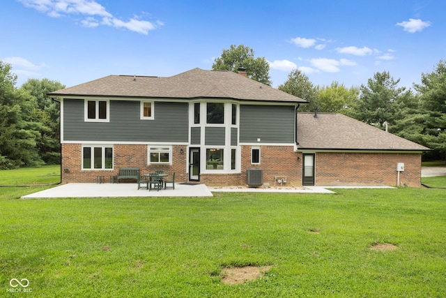 rear view of property with central AC, a lawn, and a patio