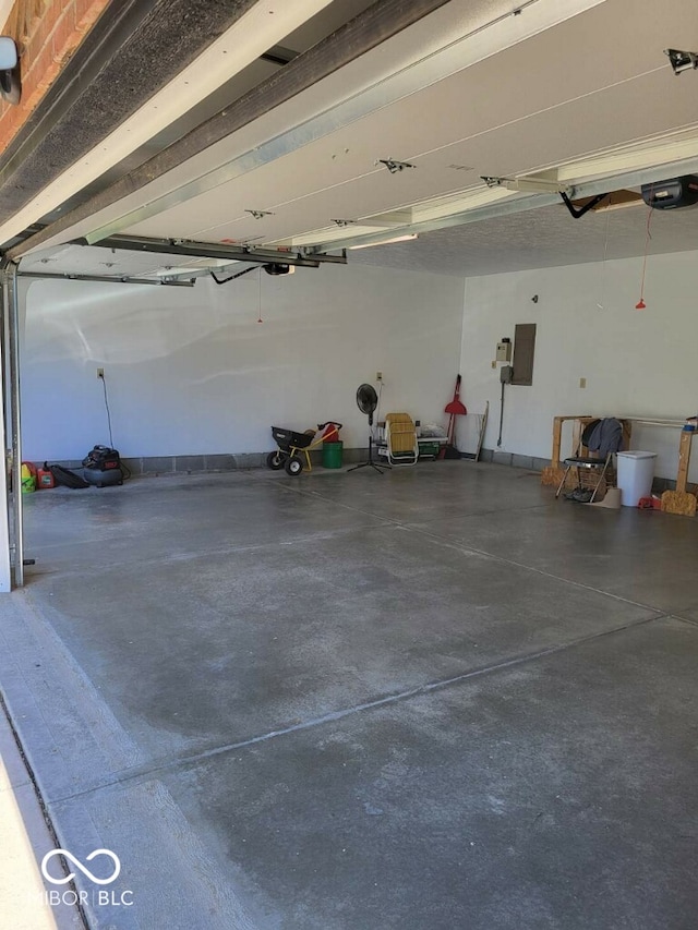 garage with electric panel and a garage door opener