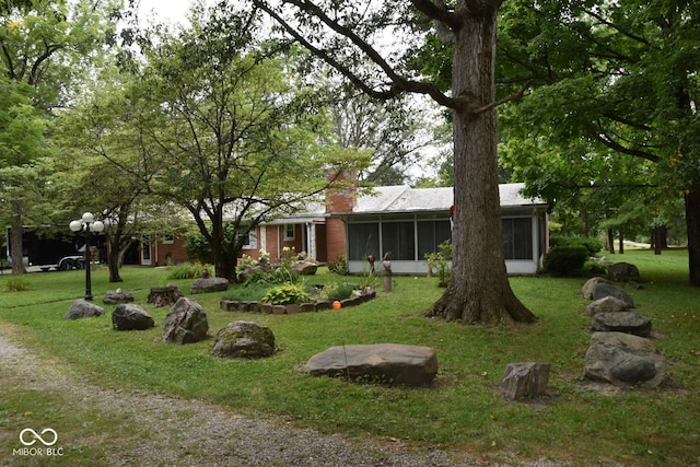 ranch-style home with a sunroom and a front yard