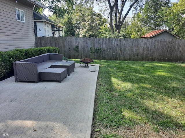 view of yard featuring an outdoor living space with a fire pit and a patio