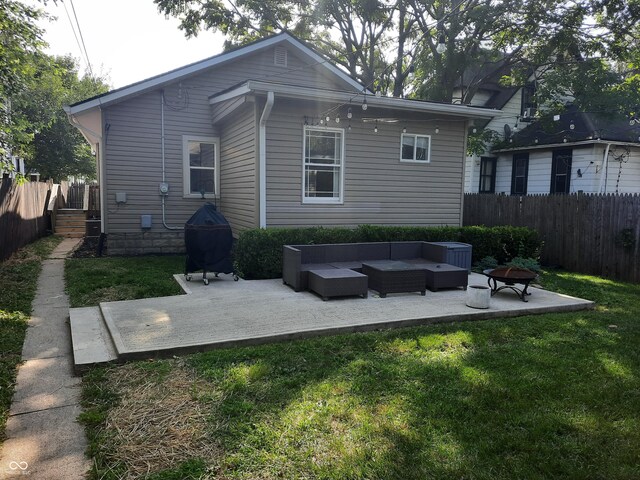 back of property with a lawn, a patio, and an outdoor hangout area