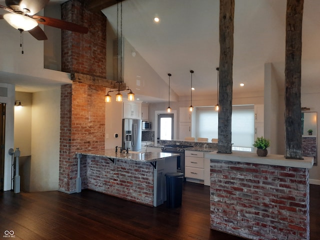 kitchen featuring high vaulted ceiling, white cabinetry, high quality appliances, and dark wood-type flooring