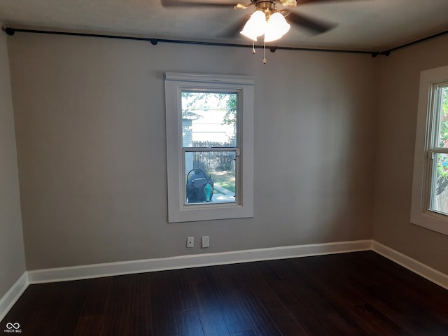 unfurnished room featuring ceiling fan, a wealth of natural light, and wood-type flooring