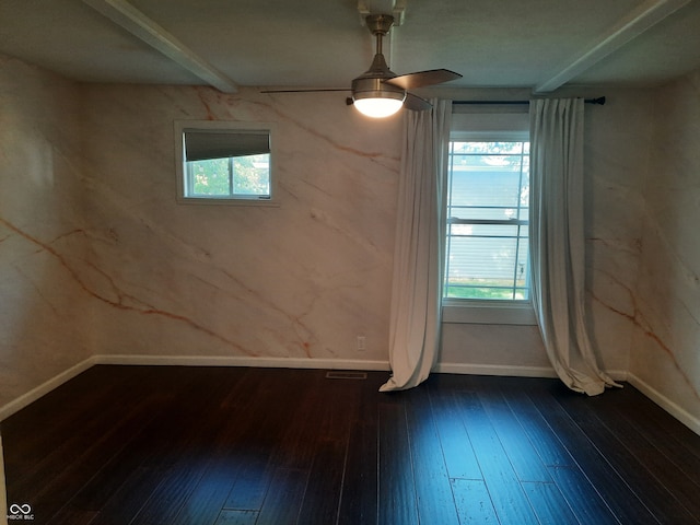 empty room with ceiling fan, a wealth of natural light, and wood-type flooring