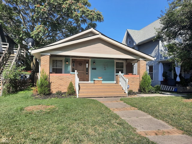 bungalow-style house featuring a front lawn and a porch