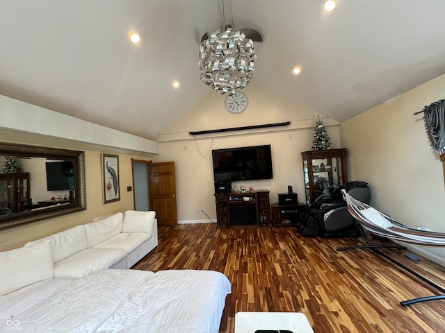 living room featuring hardwood / wood-style flooring, a chandelier, and high vaulted ceiling