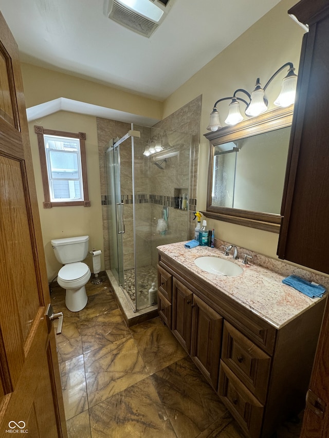 bathroom with tile patterned floors, toilet, a shower with shower door, and vanity