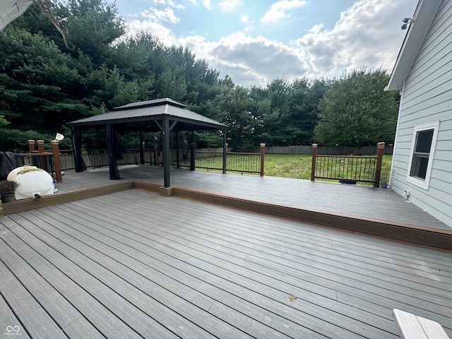 wooden terrace featuring a gazebo