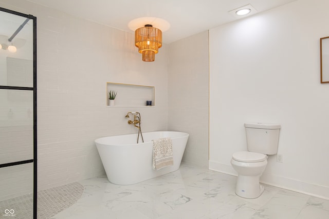 bathroom with toilet, tile patterned floors, and a bath