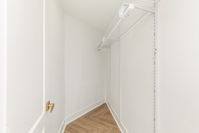 walk in closet featuring light parquet flooring