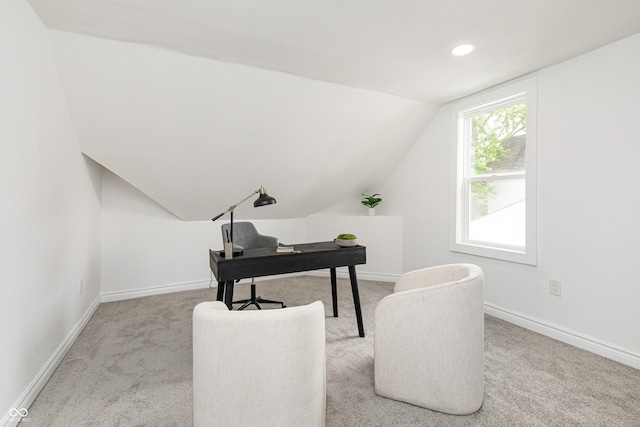 office with light carpet and vaulted ceiling