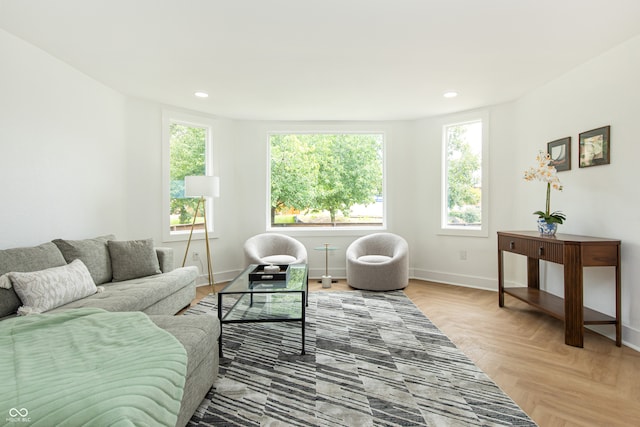 living room featuring plenty of natural light and light parquet flooring