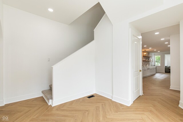 staircase featuring light parquet floors