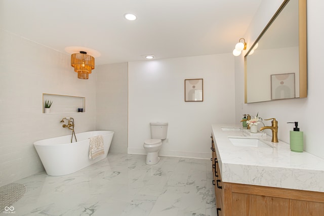 bathroom featuring a tub, toilet, double sink vanity, and tile patterned flooring