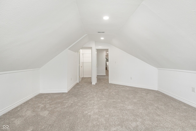 additional living space with lofted ceiling and light colored carpet