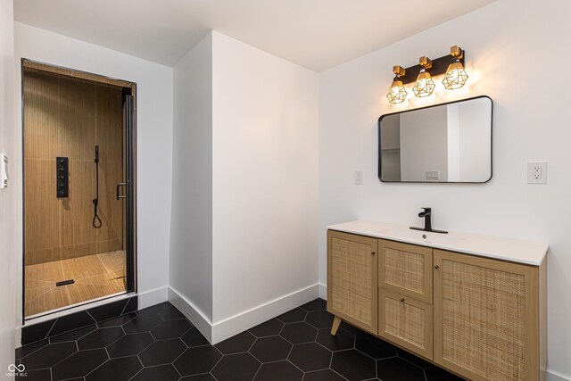 bathroom featuring vanity, tiled shower, and tile patterned flooring