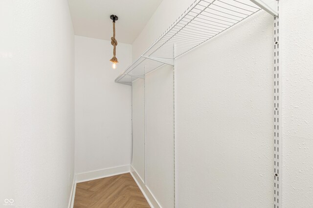 walk in closet featuring light parquet floors