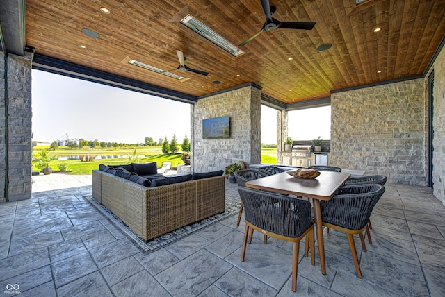 view of patio / terrace featuring an outdoor living space with a fireplace and ceiling fan