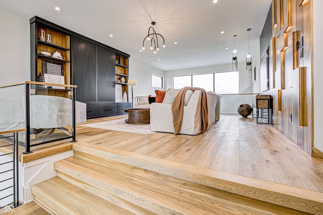 living room with a chandelier and light hardwood / wood-style floors