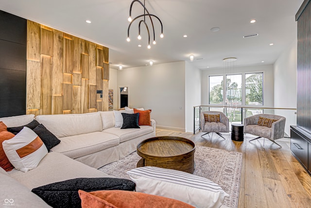 living room featuring light hardwood / wood-style floors and a chandelier