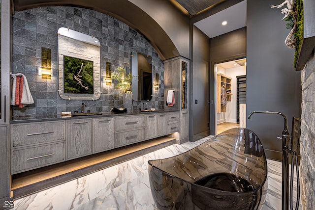 bathroom with vanity and tile walls