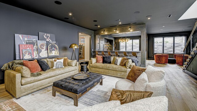 living room featuring a notable chandelier and light hardwood / wood-style flooring