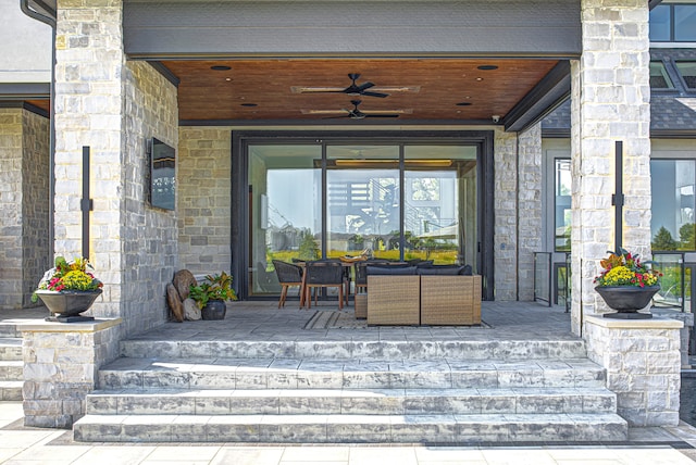 view of exterior entry featuring ceiling fan