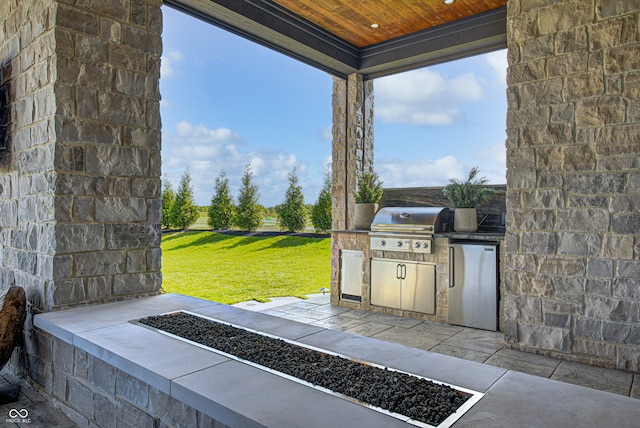 view of patio / terrace featuring a grill and exterior kitchen