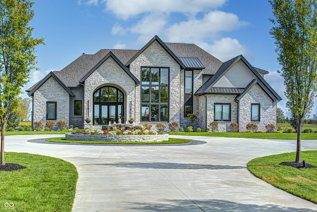 view of front facade featuring a front yard and french doors