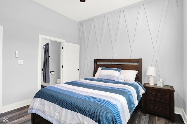 bedroom featuring ensuite bath, ceiling fan, and dark hardwood / wood-style flooring