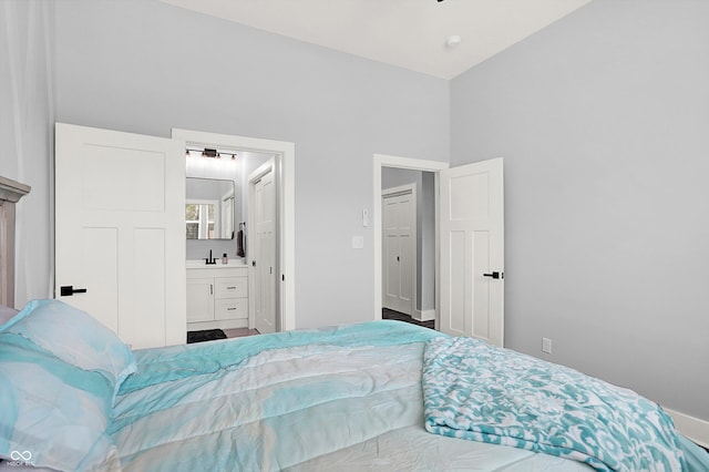 bedroom featuring ensuite bathroom and sink