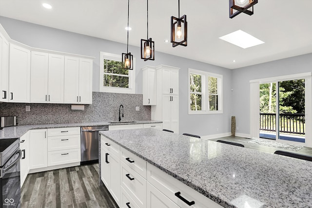 kitchen with dishwasher, dark hardwood / wood-style flooring, light stone countertops, decorative backsplash, and sink