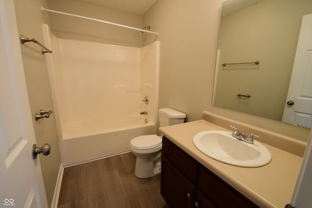 full bathroom featuring tub / shower combination, hardwood / wood-style flooring, vanity, and toilet