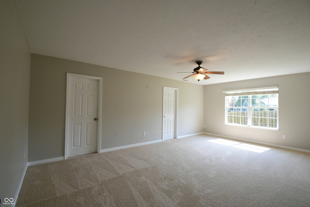 spare room featuring ceiling fan and carpet flooring