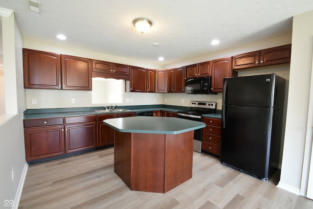 kitchen featuring black appliances, sink, a kitchen island, and light hardwood / wood-style floors