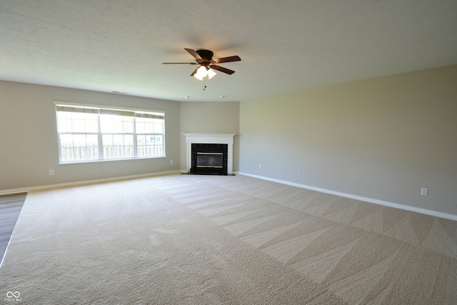 unfurnished living room featuring light carpet and ceiling fan