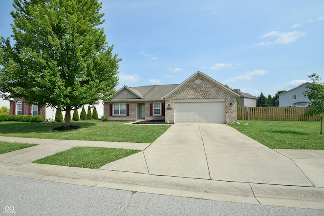 view of front of property featuring a front yard and a garage