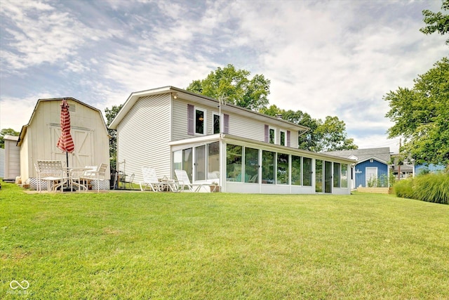 back of house featuring a lawn and a sunroom