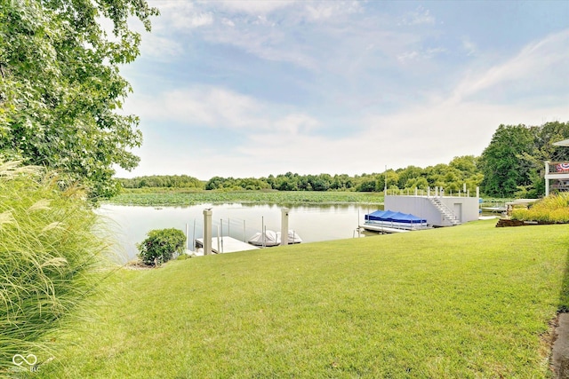 view of yard with a boat dock and a water view