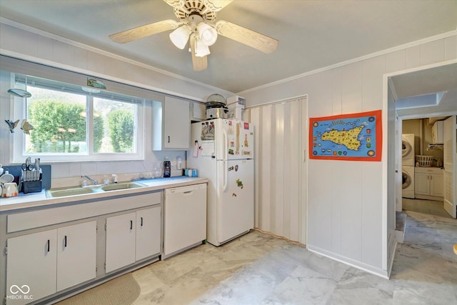 kitchen featuring sink, white appliances, ornamental molding, white cabinets, and washer / dryer