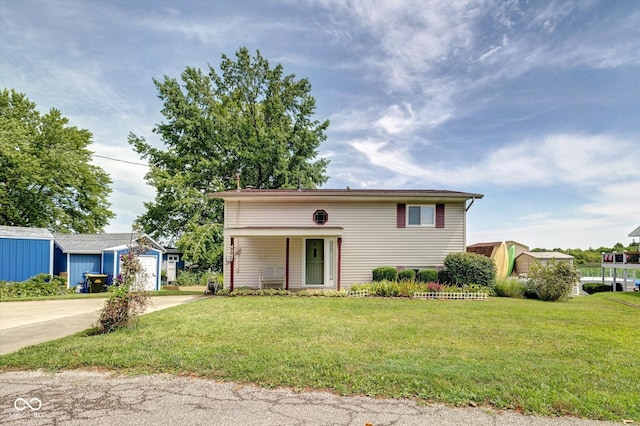 raised ranch with a front lawn and a garage