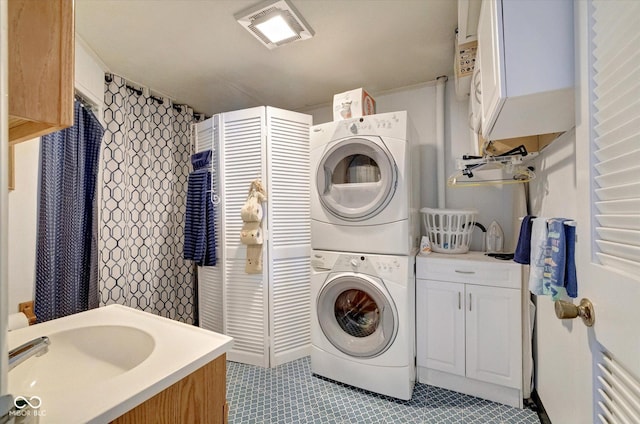 clothes washing area with stacked washer / dryer and sink