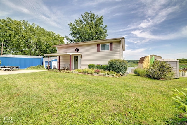 raised ranch featuring an outbuilding and a front lawn