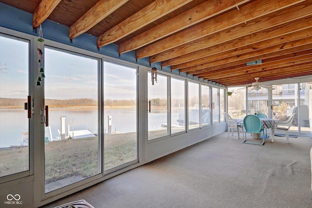 unfurnished sunroom with a water view