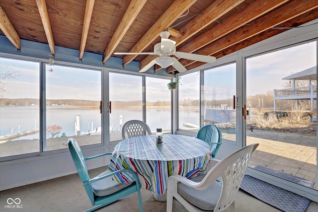 sunroom / solarium featuring ceiling fan and a water view