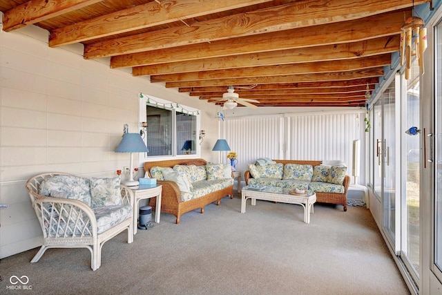 sunroom featuring beamed ceiling and ceiling fan